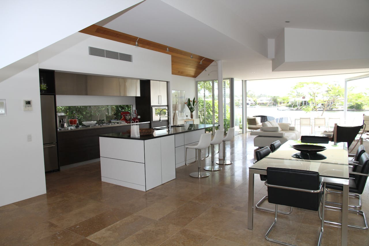about-img Spacious modern kitchen and living room with open design overlooking a scenic outdoor view.